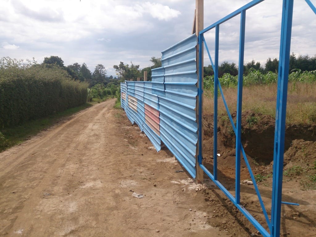 Construction of temporary fence at mission center site.
