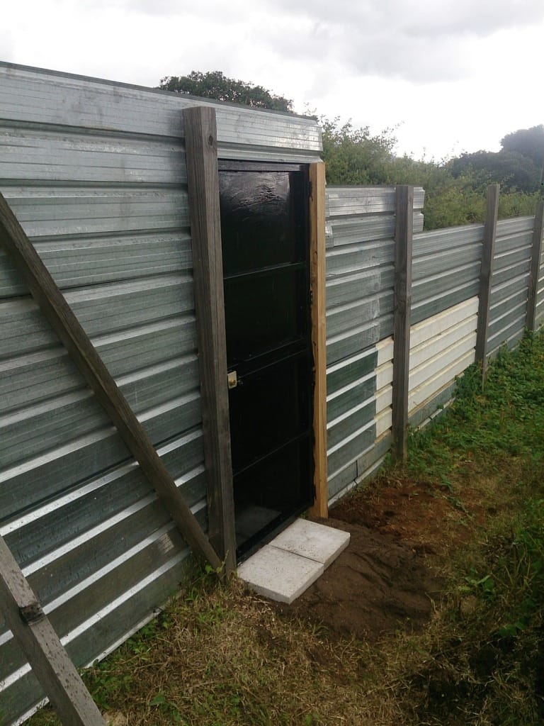 Temporary door in construction fence.